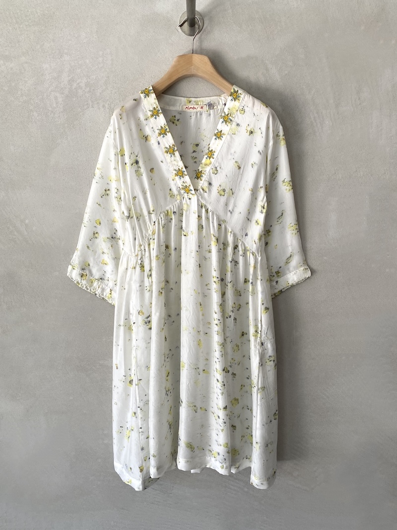 Abito bianco in seta habotai dipinta a mano, scollo a V con bordo ricamato, spalla scesa, manica lunga ampia a kimono, linea svasata con arricciatura sotto il seno, tasche laterali, lunghezza sopra il ginocchio, vestibilità morbida Nimbu