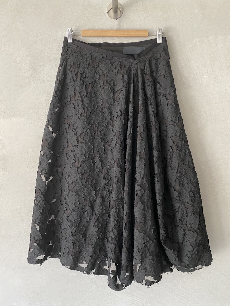 Black skirt in devoré fabric with floral motif and transparent effects, wide fit with tube and irregular hem Marc Le Bihan