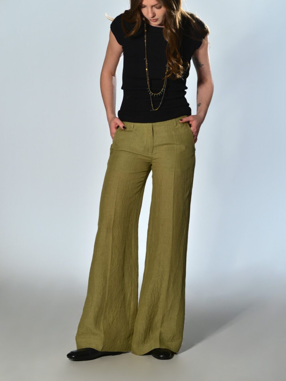Lime green straight leg trousers with a slightly flared waist, welt pockets, button and zip fastening by Marina Lari