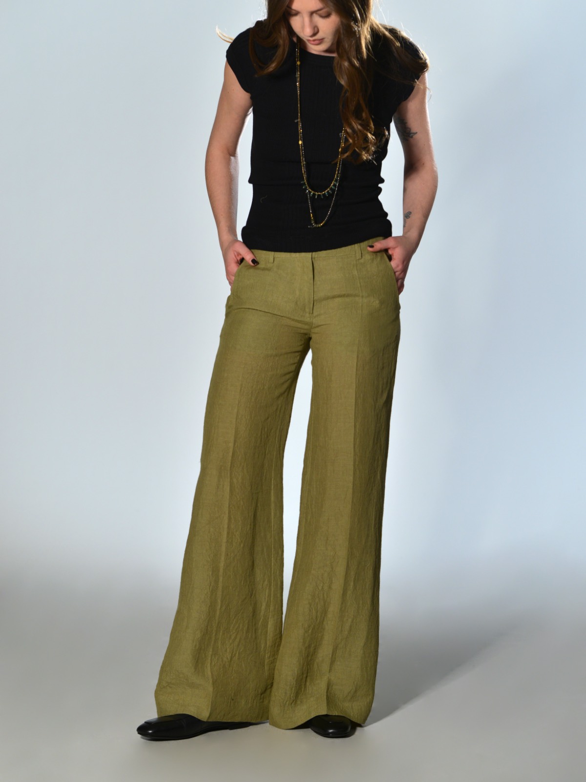 Lime green straight leg trousers with a slightly flared waist, welt pockets, button and zip fastening by Marina Lari
