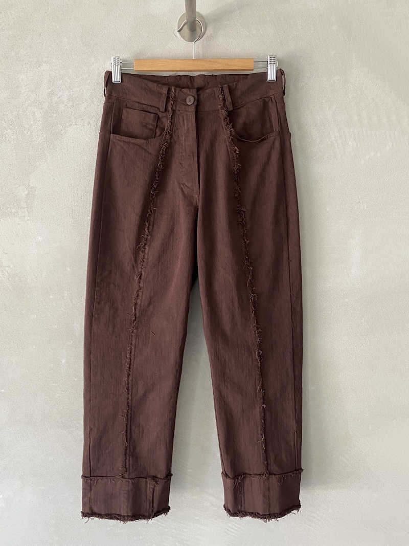 Pantaloni crop marroni in denim tinto in capo, modello cinque tasche con orlo e cuciture centrali a vivo sfilacciato, Serie Numerica.