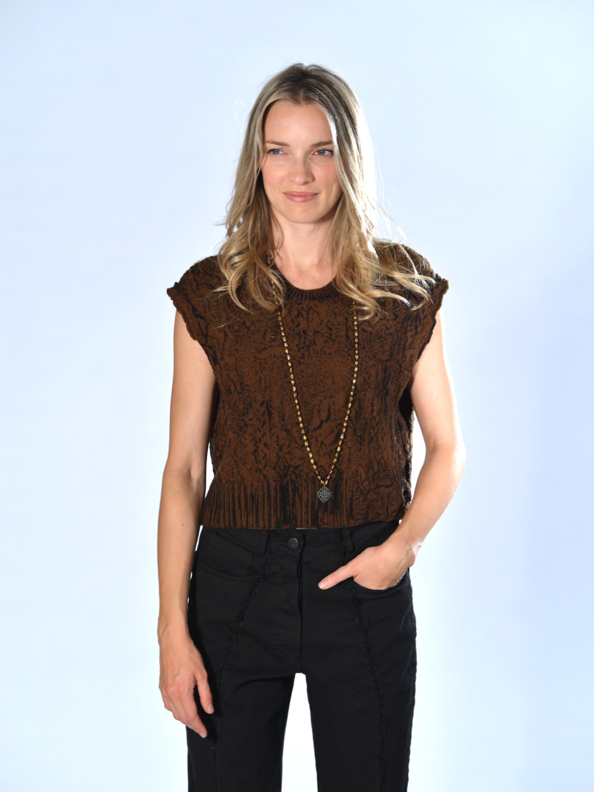 Gilet crop ruggine in maglia con lavorazione a rilievo, trattamento sfumato a mano, girocollo a costine e spalla scesa, Serie Numerica.