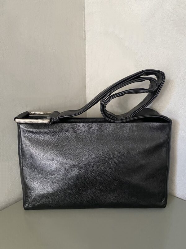 Rectangular black leather bag with a soft structure, long shoulder strap, and rectangular metal element in aged silver-effect zamak - AUTENTICA504