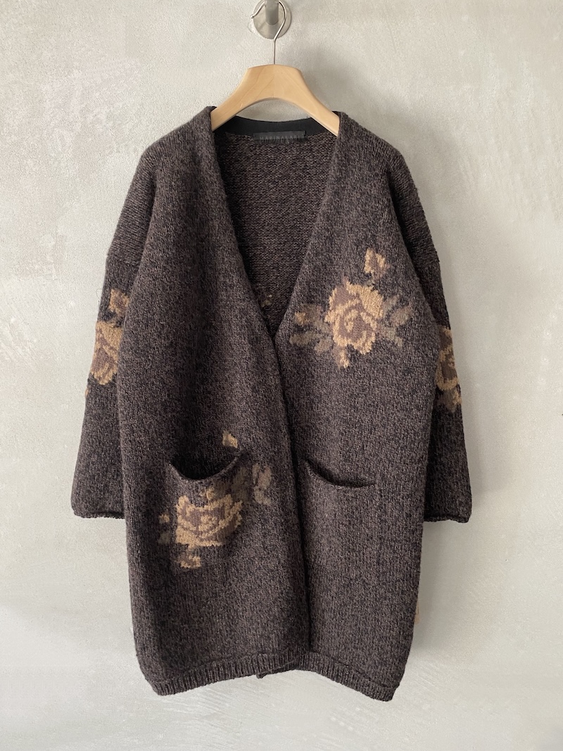 Cardigan lungo marrone in lana merino chiné con intarsi floreali Marina Lari Cardigan lungo marrone in lana merino chiné, con intarsi floreali a contrasto, tasche applicate e vestibilità over, Marina Lari.
