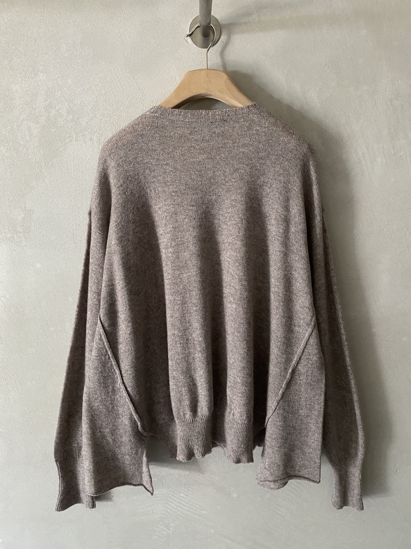 Marina Lari's beige oversized sweater in lightweight cashmere with visible stitching