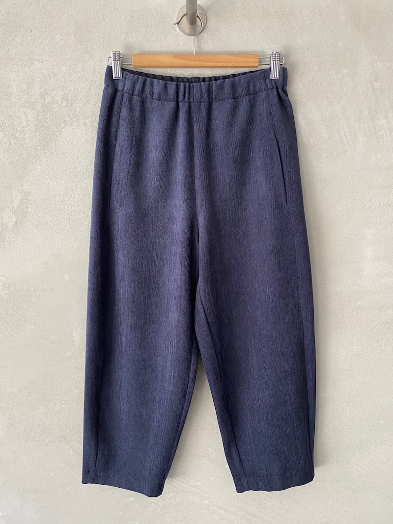 Blue ankle-length trousers in stretch herringbone fabric, with wide legs, high elasticated waist and dropped crotch, Marina Lari.